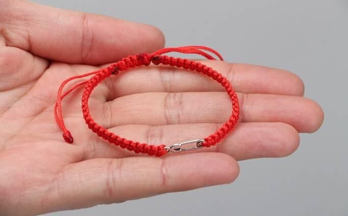 Red thread that protects from evil (on the left wrist) and attracts happiness (on the right wrist)